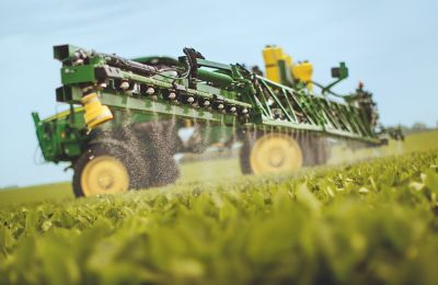 Side view active sprayer in soybean field