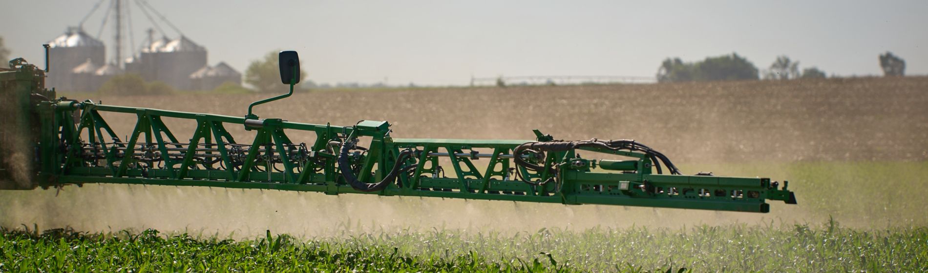 sprayer arm in corn field
