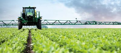 sprayer spraying field of soybeans