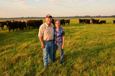 Couple standing in their pasture