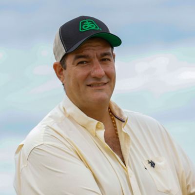 Farmer looking at the camera with a Pioneer hat