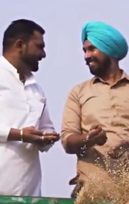 two farmers with grain