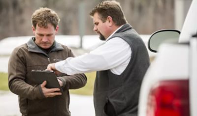 Two men looking at an ipad