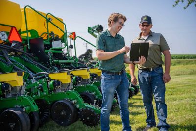 Farmer and rep calibrating farm equipment
