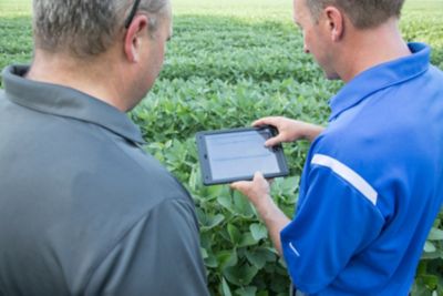 Men with iPad in Soybean field