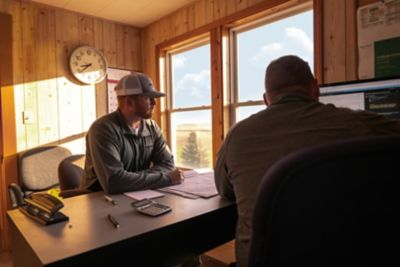 Two men talking at a table