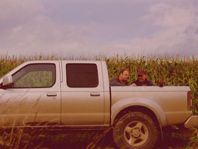 Two men talking at a truck bed