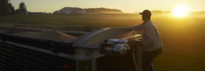 Man Climbing Trailer at Sunrise