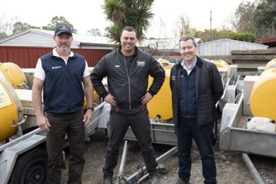 Hugh Mayo (Corteva Agriscience), Bob North and Chris Brown (Corteva Agriscience) inspecting the Naturalure® trailers used in fruit fly prevention in the Adelaide Hills of SA.