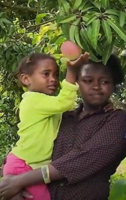 woman holding young daughter