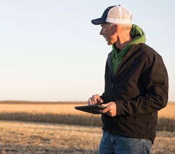 man in field with tablet