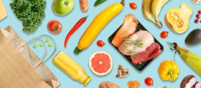 Array of meats, fruits, vegetables spread out.