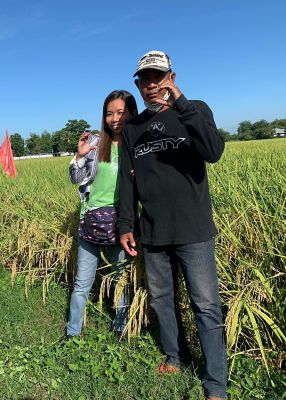 husband and wife doing the Corteva "C" hand sign