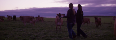 Two women in field, purple sky