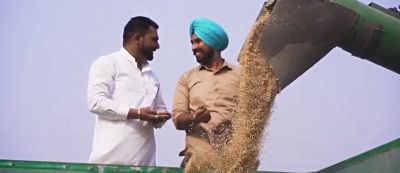 two men conversing next to farm equipment
