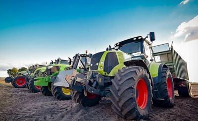 Row of tractors under blue sky