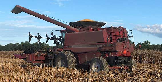 This is a photo showing a combine with aftermarket header reel for harvesting lodged corn.