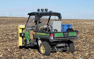 Soil sampling a large field with a mounted hydraulic sampler.