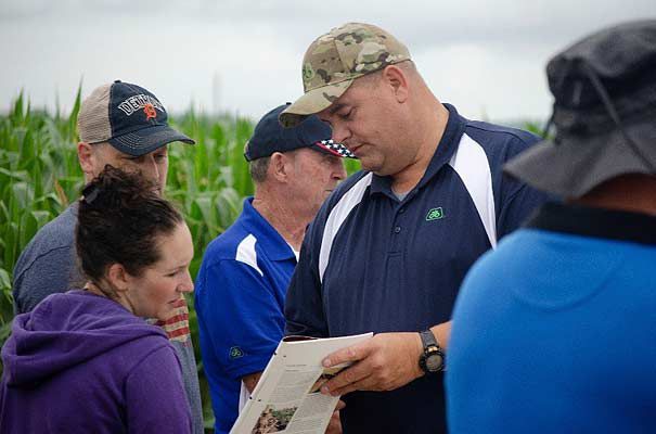 Photo - Pioneer Field Agronomist Scott Dickey sharing crop management information with a S.A.V.E. participant.