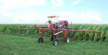 A high-clearance sprayer modified to seed cover crops into standing corn.