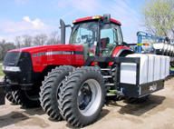 Case IH tractor equipped with tanks for liquid starter application at planting.