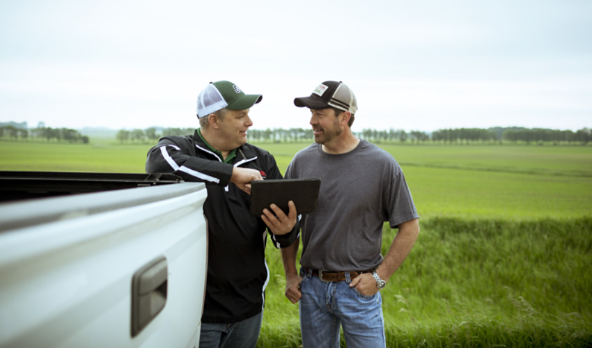 Men leaning on a truck