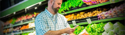 Man in grocery store in produce aisle