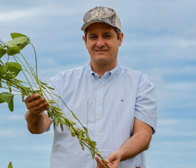 Farmer holding a soybean plant