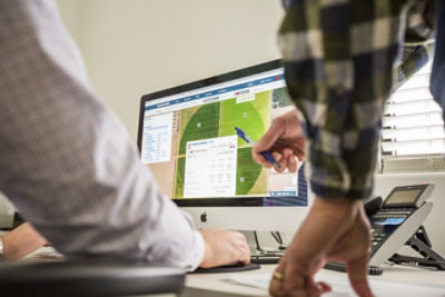 Agrometeorology - 2 men viewing a computer screen with charts