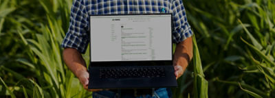 Imagem de uma mão segurando um notebook e na tela aparece a homepage do blog antigo da Pioneer