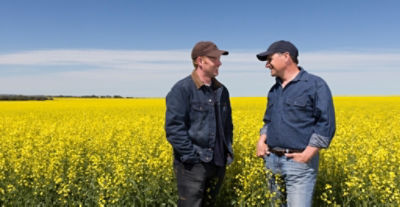 two men in field talking