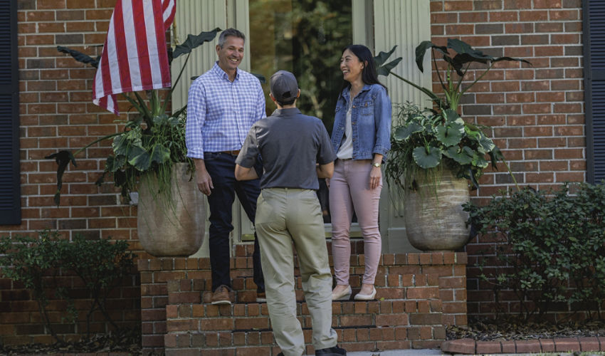 Certified Sentricon Specialist greets homeowners on front porch