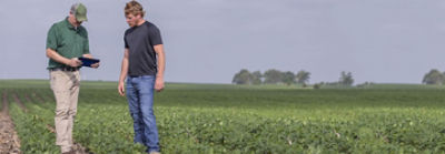 Enlist Field Specialist and Farmer in field with tablet