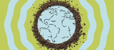 A drawing of a map of Earth with dirt surrounding the drawing.