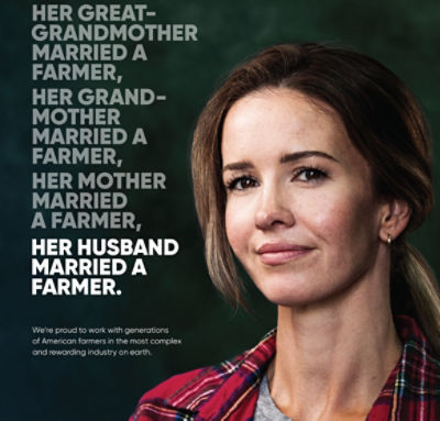 A woman farmer who is smiling, to convey how Corteva supports women in farming.