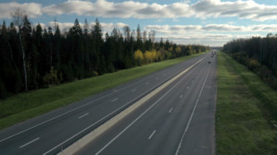 Two lane highway with trees on each side