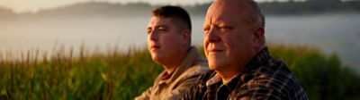Father and Son farmers in field at dawn