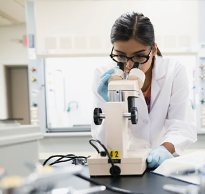 Scientist using microscope