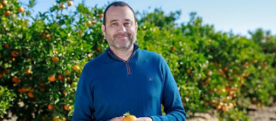 Farmer-Smiling-With-Tangerine
