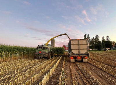 Photo - corn harvest operation - red barn in background