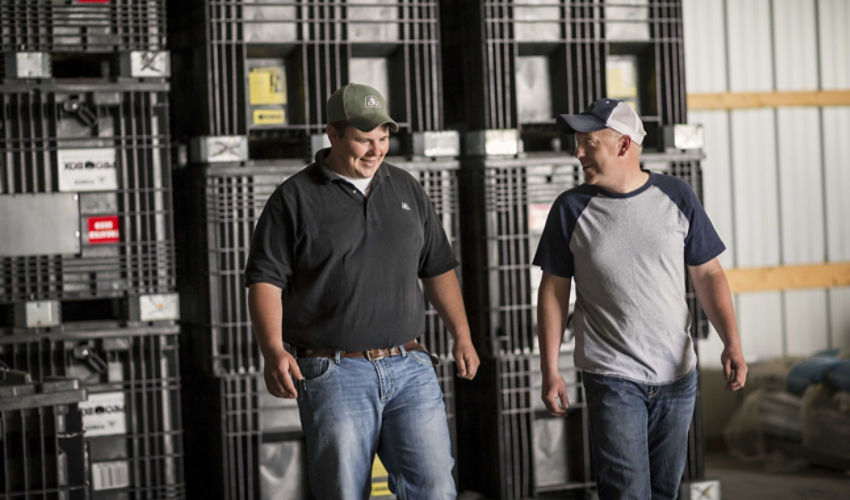 Farmer and rep with bulk boxes