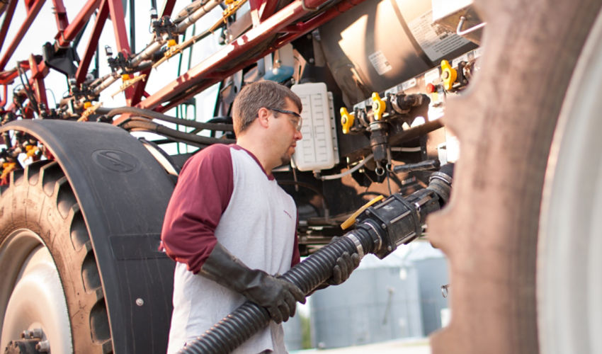 Farmer filling sprayer