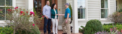 A certified Sentricon specialist shaking hands with a homeowner