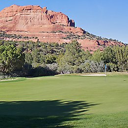 Image of golf course at base of mountains
