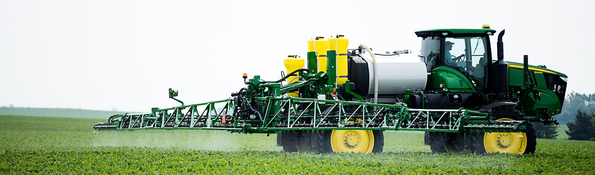 Green sprayer in young soybean field