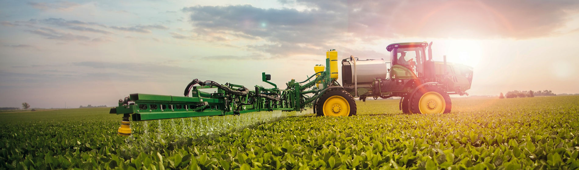 Sideview from horizon at sunrise sprayer in early soybeans