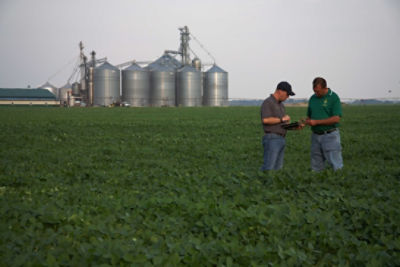 Sales rep and customer in field.