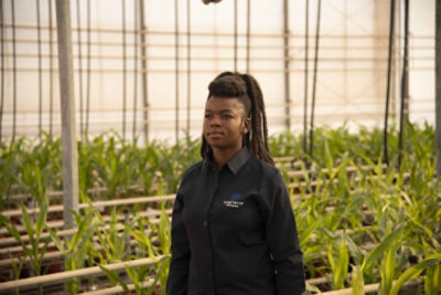woman wearing a Corteva shirt in an indoor crop facility