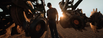 Man inspecting tilling equipment