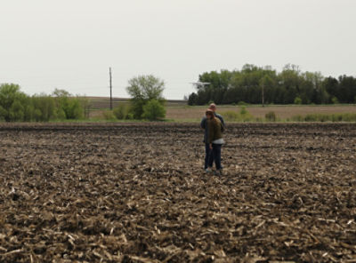 Two people in field with drone